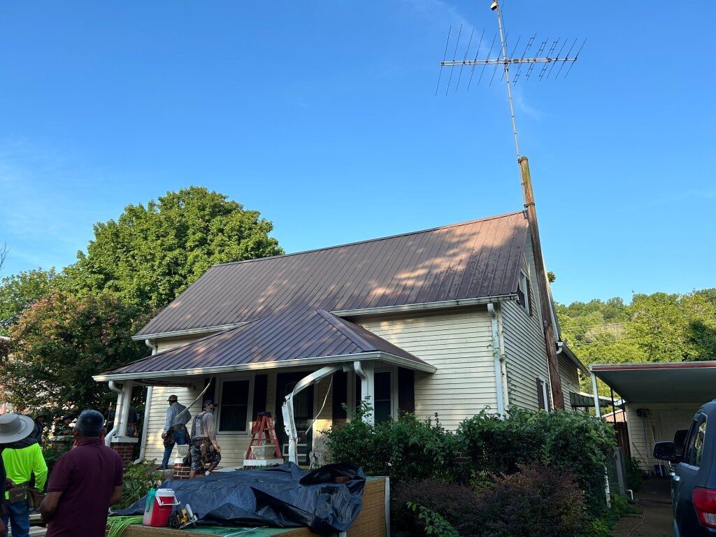 A Middle Tennessee farmhouse mid-renovation, with the original roof and siding still exposed
